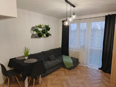 a living room with a couch and a table at Perfekt Place in Oświęcim