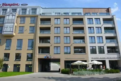 a large building with umbrellas in front of it at Loft Place Oswiecim - Air Conditioning, City Center, Self Check-in in Oświęcim