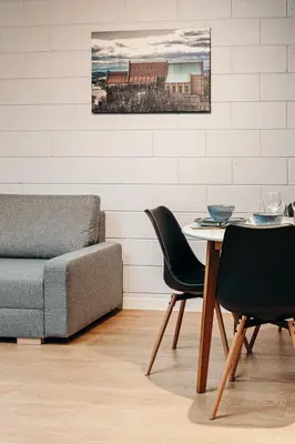 a living room with a couch and a table and chairs at Loft Place Oswiecim - Air Conditioning, City Center, Self Check-in in Oświęcim