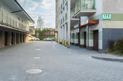 an empty street with a car parked next to buildings at Podłęska Comfort Apartment by BookingHost in Kraków