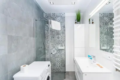 a bathroom with a shower and a toilet and a sink at Podłęska Comfort Apartment by BookingHost in Kraków