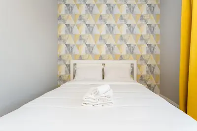 a bedroom with a bed with towels on it at Podłęska Comfort Apartment by BookingHost in Kraków