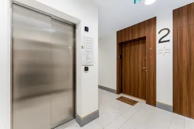 a metal elevator in a building with a door at Noble Residence Luxury Suites in Kraków