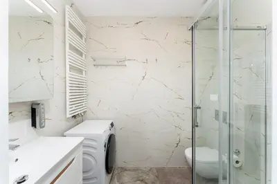 a bathroom with a toilet and a glass shower at Noble Residence Luxury Suites in Kraków