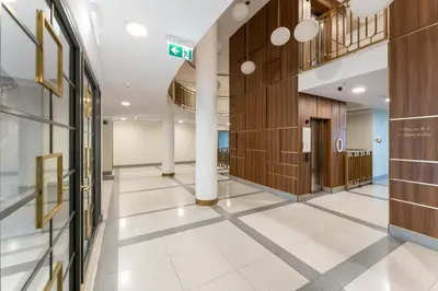 an empty hallway of a building with a hallway at Noble Residence Luxury Suites in Kraków