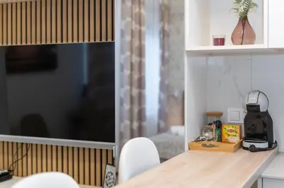 a kitchen with a table and chairs in a room at Noble Residence Luxury Suites in Kraków