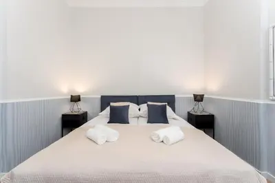 a bedroom with a large bed with two night stands at Blue Den Old Town Apartments in Kraków