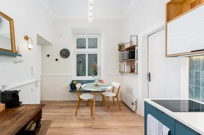 a kitchen and dining room with a table and chairs at Blue Den Old Town Apartments in Kraków