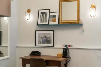 a dining room with a table and a mirror at Blue Den Old Town Apartments in Kraków