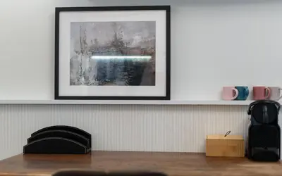 a picture on a white wall with a picture on a shelf at Blue Den Old Town Apartments in Kraków