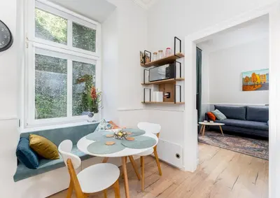 a living room with a table and chairs and a couch at Blue Den Old Town Apartments in Kraków