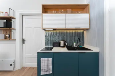 a kitchen with a blue and white counter top at Blue Den Old Town Apartments in Kraków