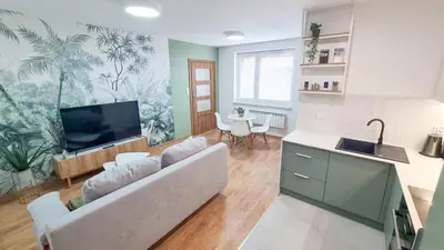 a living room with a couch and a flat screen tv at Apartament 2A na ul Wiejskiej 32c in Oświęcim