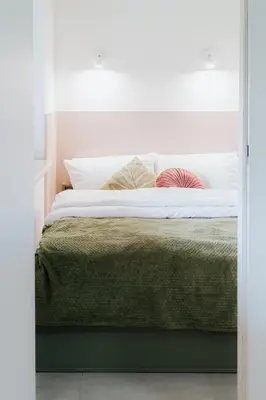 a bedroom with a bed with white sheets and a window at Apartament 3A na ul Wiejskiej 32c in Oświęcim