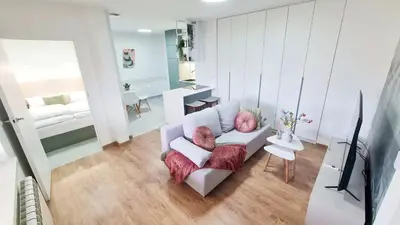 a living room with a couch and a television at Apartament 3A na ul Wiejskiej 32c in Oświęcim