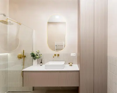 a bathroom with a sink and a mirror at Parkside Family Suite in Kraków