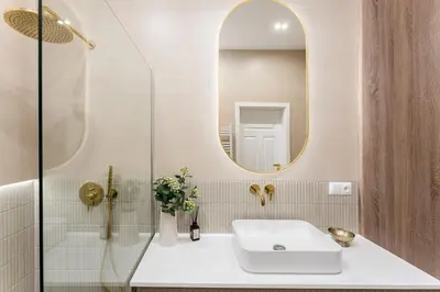 a bathroom with a sink and a mirror at Parkside Family Suite in Kraków