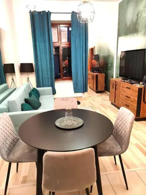 a living room with a table and a couch at Old Town Apartments - Kingi Street in Kraków