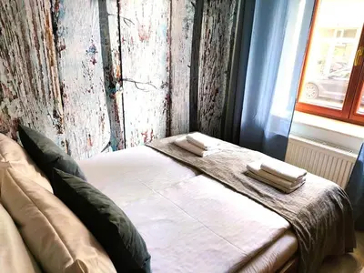 a bedroom with a bed with two towels on it at Old Town Apartments - Kingi Street in Kraków