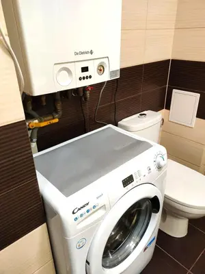 a washing machine in a bathroom with a toilet at Old Town Apartments - Kingi Street in Kraków