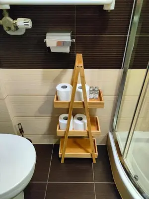 a bathroom with a toilet and a shelf with toilet paper at Old Town Apartments - Kingi Street in Kraków
