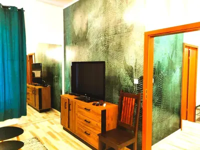 a living room with a flat screen tv on a wall at Old Town Apartments - Kingi Street in Kraków