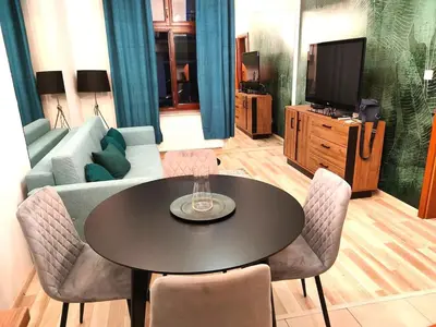 a living room with a table and a couch at Old Town Apartments - Kingi Street in Kraków