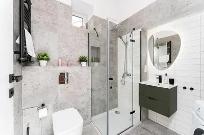 a bathroom with a shower and a toilet and a sink at Malila Premium Apartments Cracow Świętego Łazarza 3 in Kraków