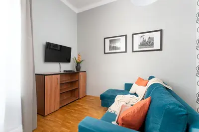 a bathroom with a sink and a washing machine at Malila Premium Apartments Cracow Świętego Łazarza 3 in Kraków
