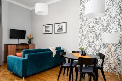 a kitchen and dining room with a table and chairs at Malila Premium Apartments Cracow Świętego Łazarza 3 in Kraków