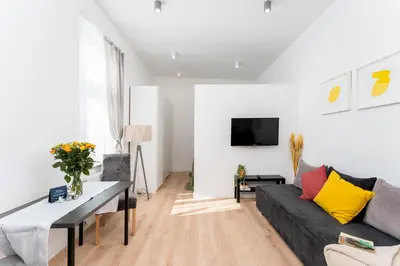 a living room with a couch and a table at Malila Premium Apartments Cracow Świętego Łazarza 3 in Kraków