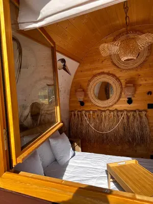 a small room with a bed in a boat at Raj na Hektarach in Wysokie