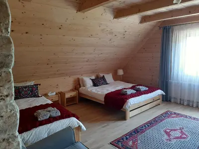 a bedroom with two beds in a log cabin at Villa of Roses in Lanckorona