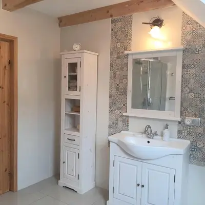 a bathroom with a white sink and a mirror at Villa of Roses in Lanckorona