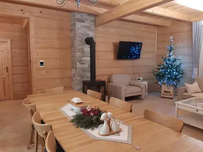 a living room with a table and a christmas tree at Villa of Roses in Lanckorona
