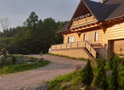 a house with a walkway next to a building at Villa of Roses in Lanckorona