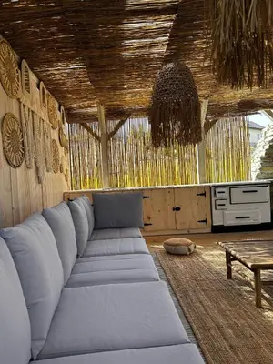 a living room with a blue couch and a table at Raj na Hektarach in Limanowa
