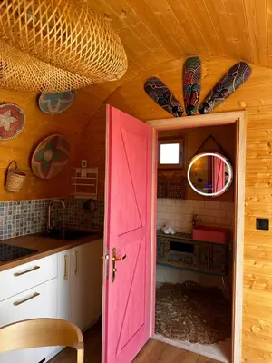 a room with a pink door in a kitchen at Raj na Hektarach in Limanowa