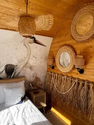 a bedroom with a bird on the wall and a bed at Raj na Hektarach in Limanowa