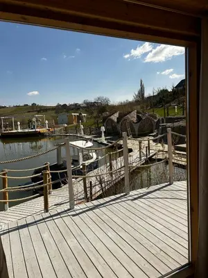 a view of a dock with a boat in the water at Raj na Hektarach in Limanowa