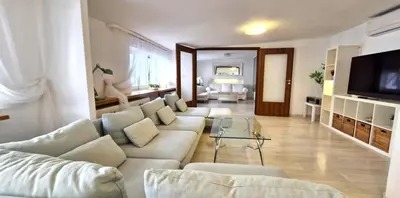 a living room with a white couch and a television at IMPERIaL 110 m2, 4 rooms, Old Town, 300m Wawel, Breakfest in Kraków