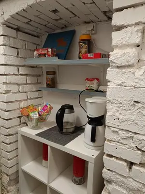a coffee maker sits on a shelf in a pantry at Kapsuła #2 Centrum in Kraków