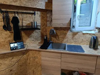 a kitchen counter with a sink and a window at Kapsuła #2 Centrum in Kraków