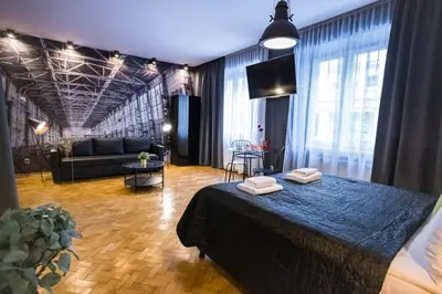 a bedroom with a bed and a living room at Jacuzzi & Relax by Leo Apartments Old Town in Kraków
