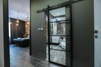 a glass door in a room with a living room at Jacuzzi & Relax by Leo Apartments Old Town in Kraków