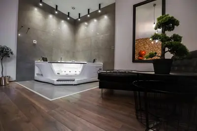 a bathroom with a bath tub in the middle of a room at Jacuzzi & Relax by Leo Apartments Old Town in Kraków
