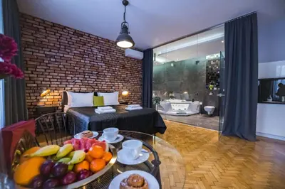 a room with a table with a bowl of fruit at Jacuzzi & Relax by Leo Apartments Old Town in Kraków