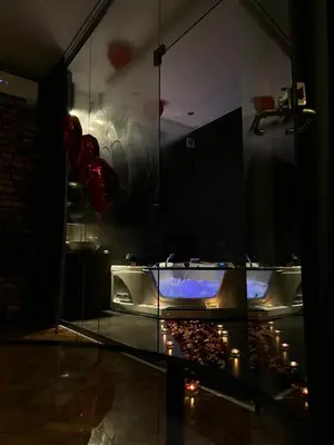 a glass display case in a room with a fireplace at Jacuzzi & Relax by Leo Apartments Old Town in Kraków