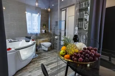 a bowl of fruit on a table in a bathroom at Jacuzzi & Relax by Leo Apartments Old Town in Kraków