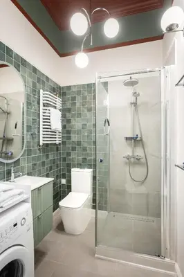 a bathroom with a shower and a toilet and a sink at Katie's Apartment in Kraków